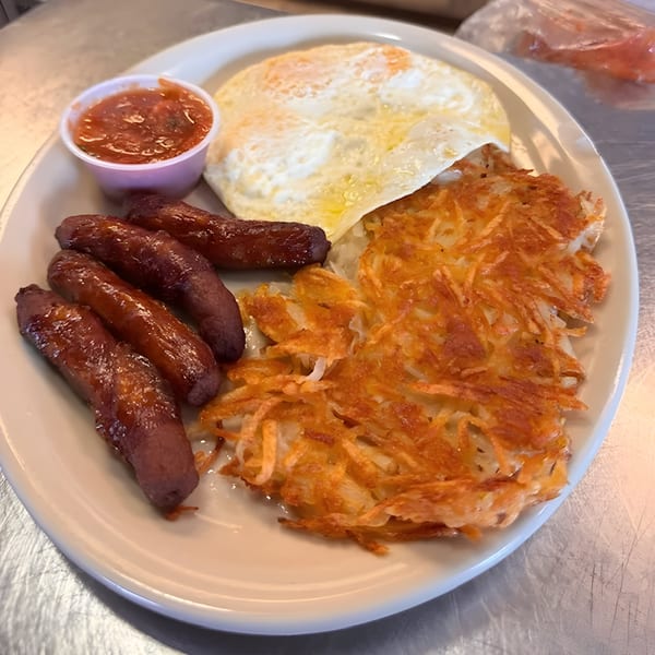Jim's Burgers & Eggs breakfast plate with sausage links, fried eggs, hash browns, and salsa.